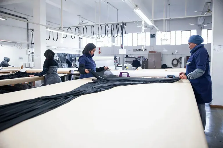 Libacce production floor in Istanbul, with staff laying out coated fabric on cutting tables