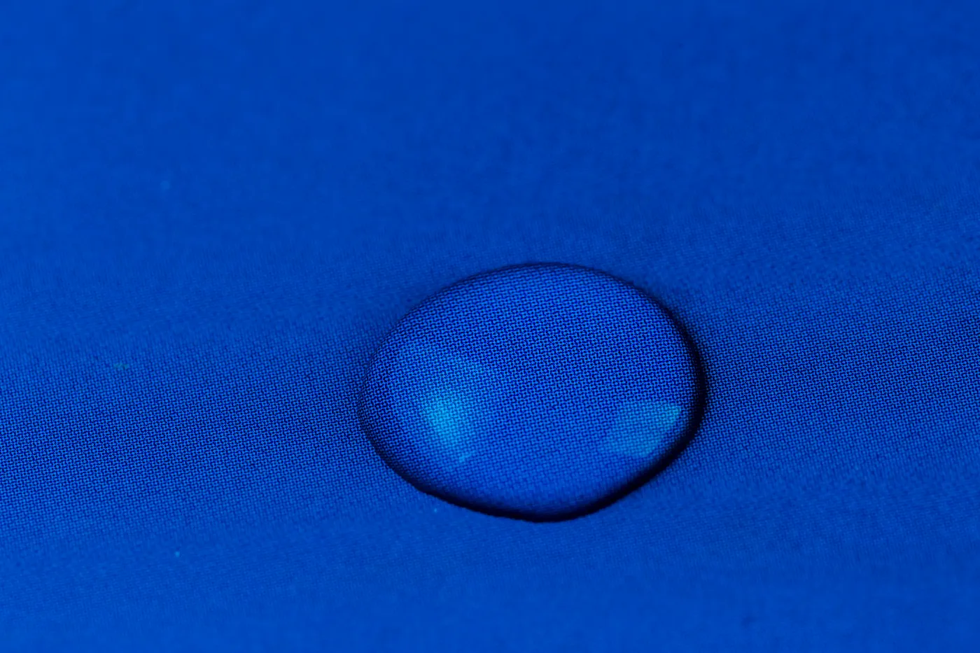 Water drop beading on blue fabric